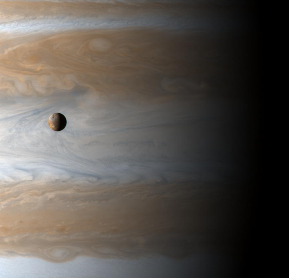The Galilean satellite Io floats above the cloudtops of Jupiter in this image captured on the dawn of the new millennium, January 1, 2001 10:00 UTC (spacecraft time), two days after Cassini's closest approach.