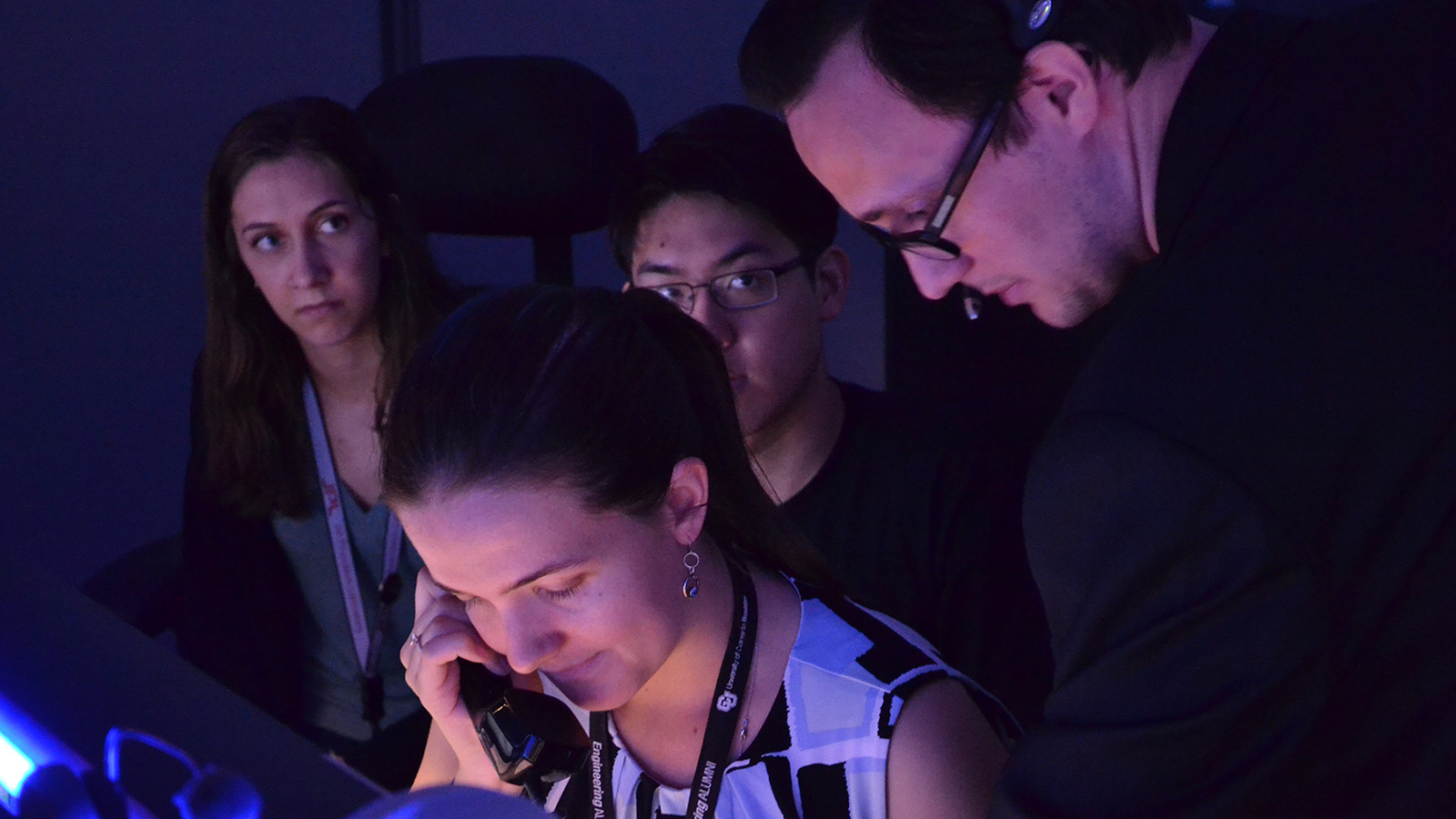 Color image of college students in mission control.