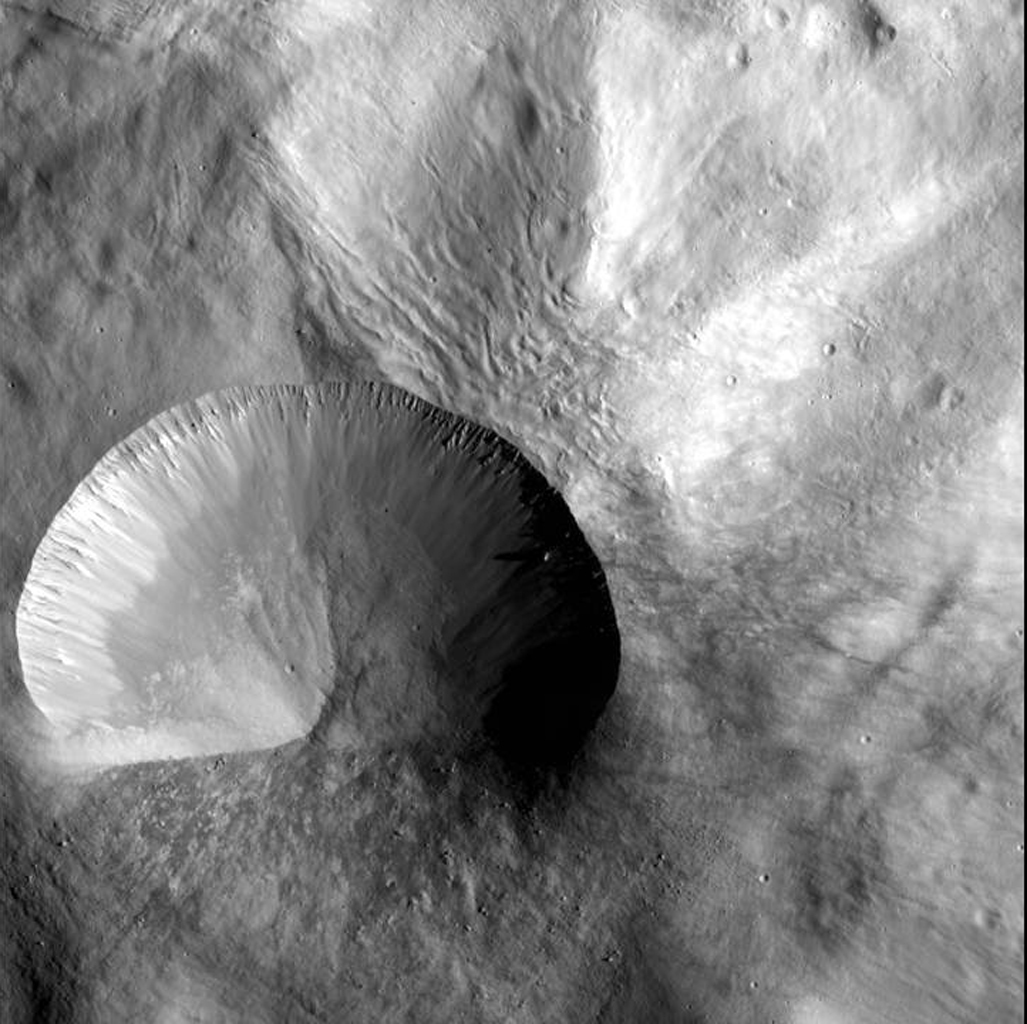Steep-sided crater on surface of an asteroid.