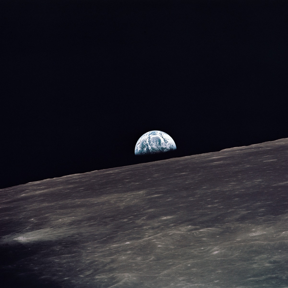 Gibbous phase Earth above lunar plain