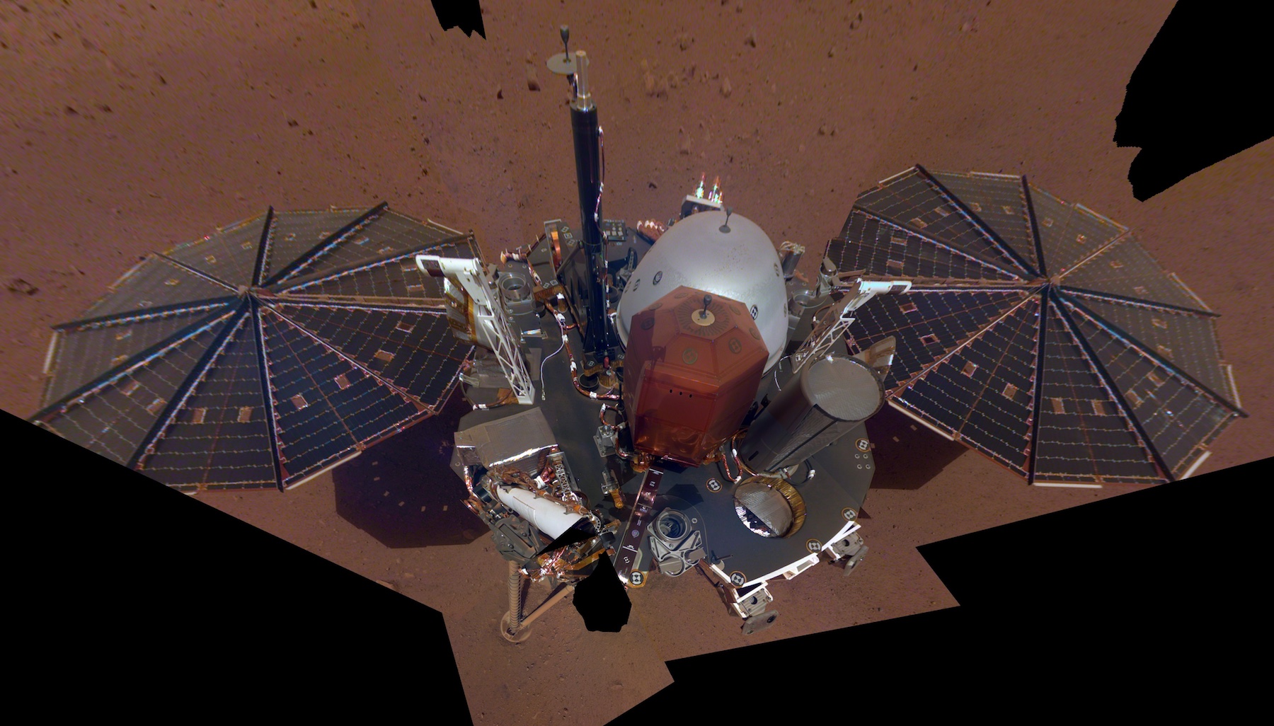 spacecraft on reddish surface seen from above