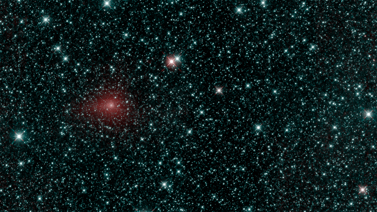 Fuzzy series of dots of a comet against a background of bright stars.