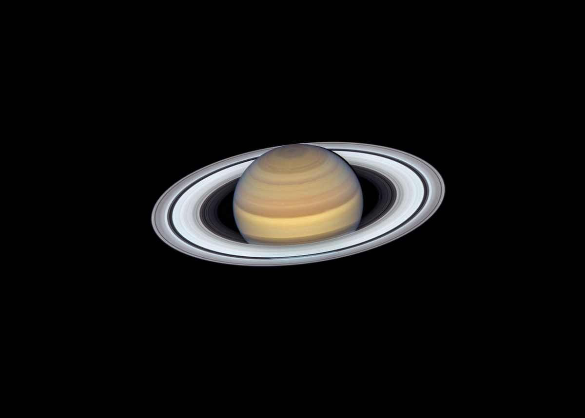 bright saturn and rings against black space