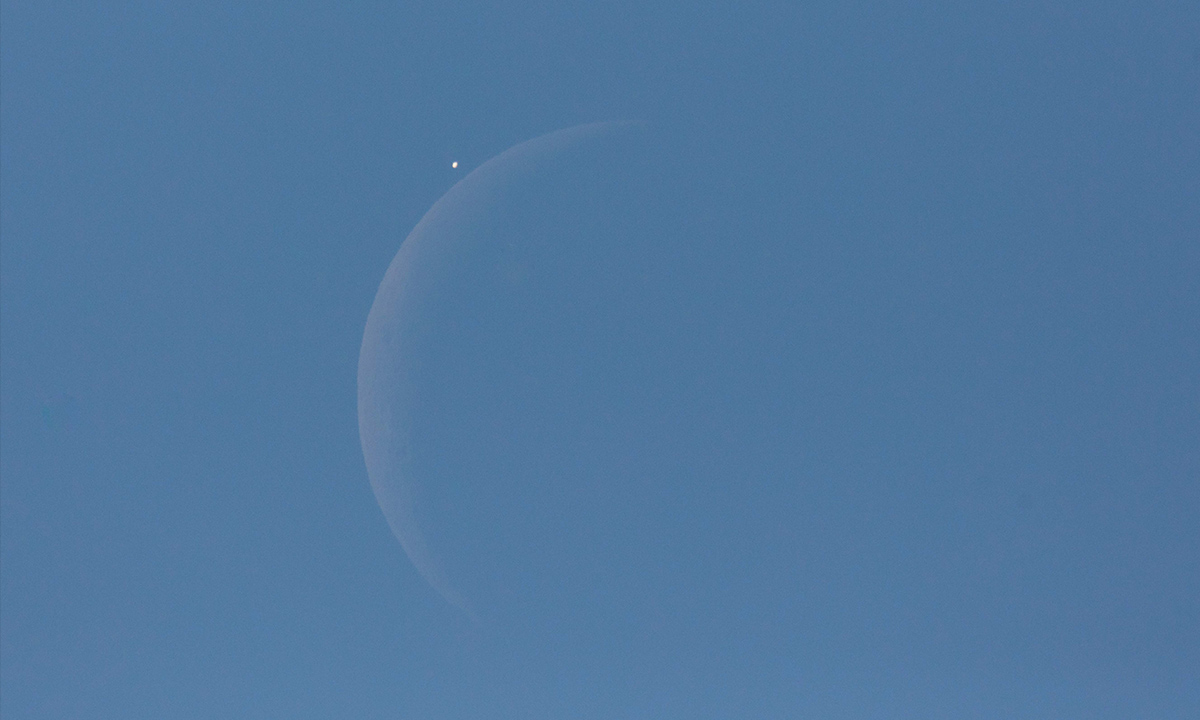 Venus is seen next to the crescent moon during the daytime, prior to the start of occultation, on Monday, 7 December 2015 in Washington, D.C.