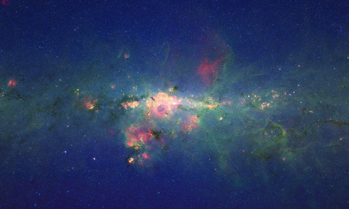 The region around the center of our Milky Way galaxy glows colorfully in this new version of an image taken by NASA's Spitzer Space Telescope.
