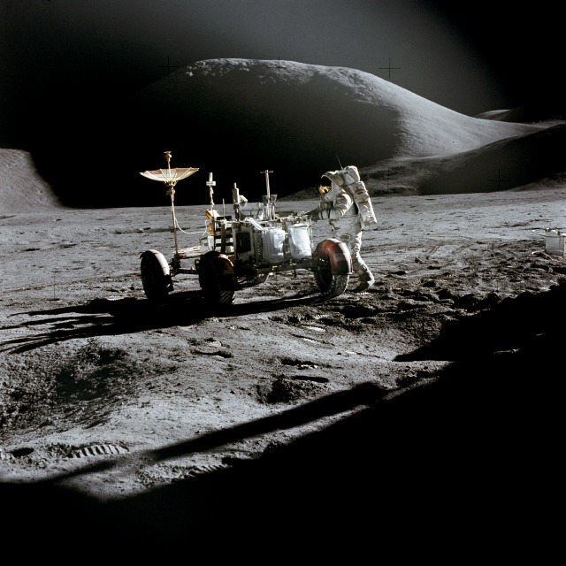 Astronaut James B. Irwin standing next to the Lunar Roving Vehicle on the moon