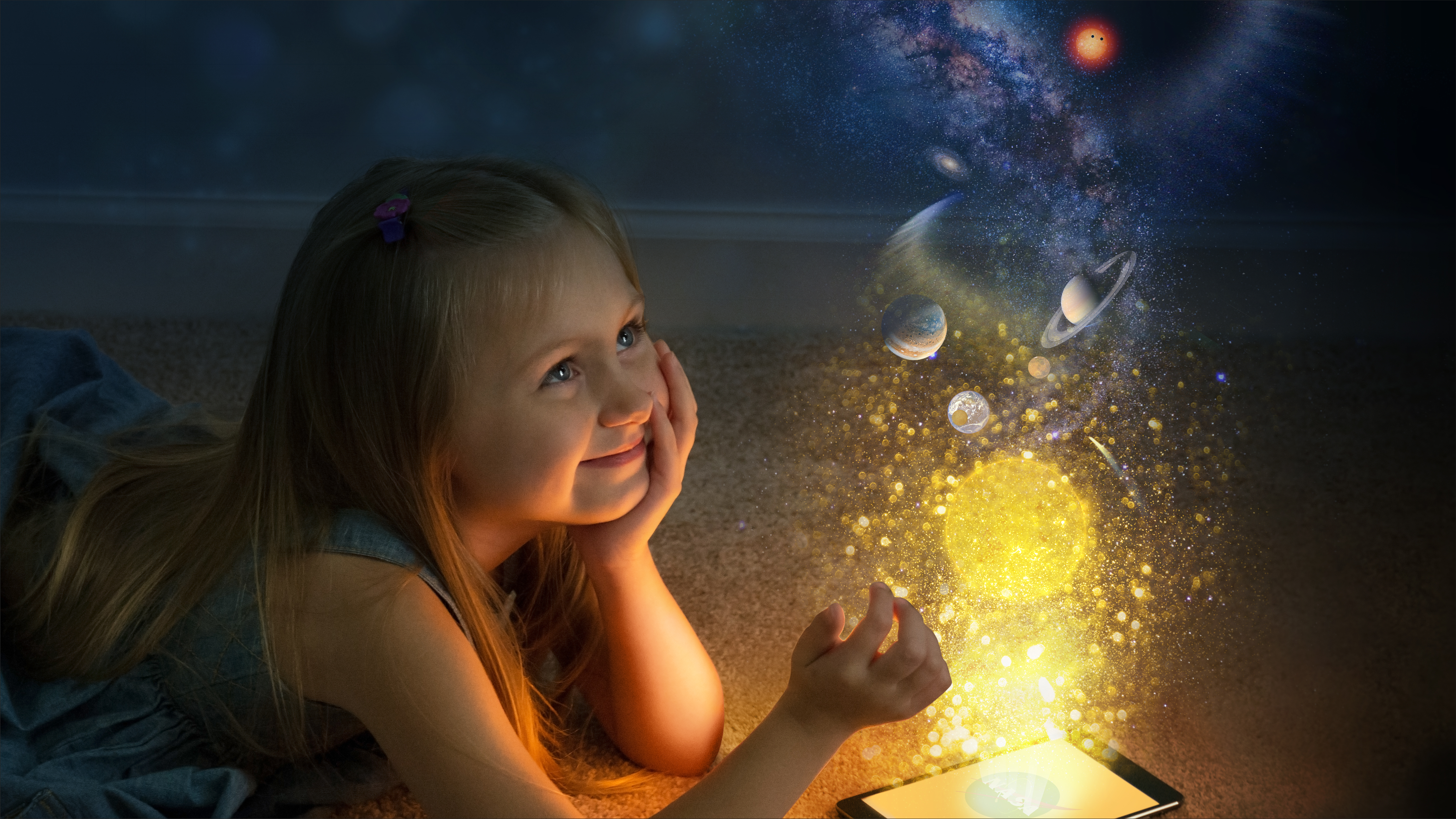 Little girl looking at a magical swirl of planets and galaxies.